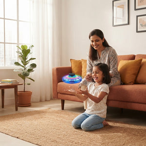 A South Asian mother and child playing with a flying orb spinner in a sunlit, warm-toned living room.